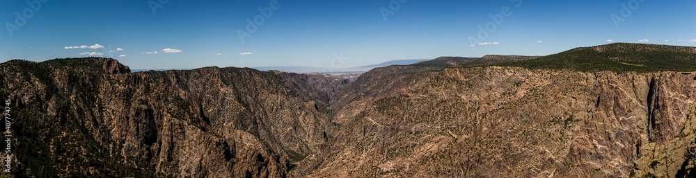 Panorama shot of gunnison river and rocky walls in black canyon of gunnison at sunny day in america Panorama shot of gunnison river and rocky walls in black canyon of gunnison at sunny day in america