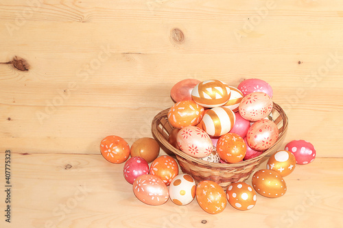 Decorated golden Easter eggs on a wooden background. greeting card, Happy Easter concept, background. Creative painting eggs at home, idea of simple drawings for coloring, place for text,