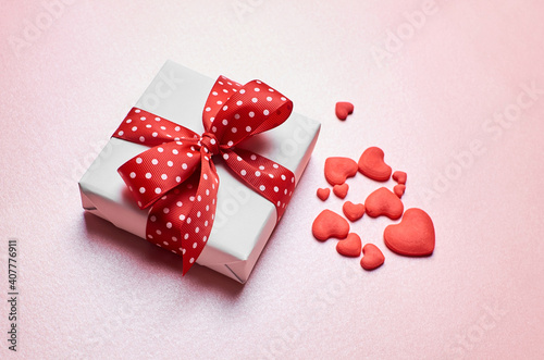 Valentines day gift box with red hearts on pink background © nikavera