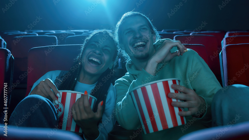 Αυτοκόλλητο Best friends, young man and woman having fun, sitting at the cinema, watching a