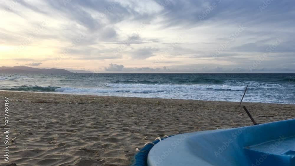 A boat on blue times sunset on the beach of wavy Mediterranean sea landscape panorama in Skikda Algeria A boat on blue times sunset on the beach of wavy Mediterranean sea landscape panorama in Skikda Algeria