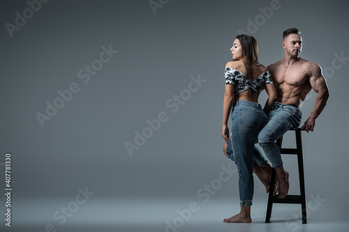 couple of athletes or bodybuilders posing with perfect body or torso at studio