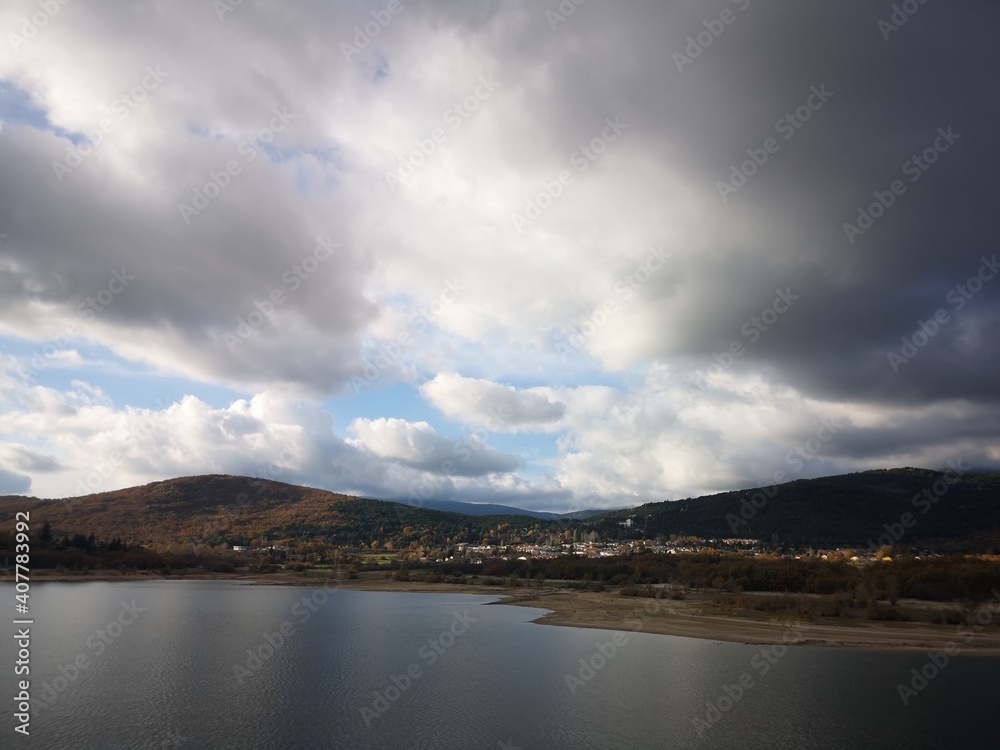 Lake in the mountains in autumn with clouds