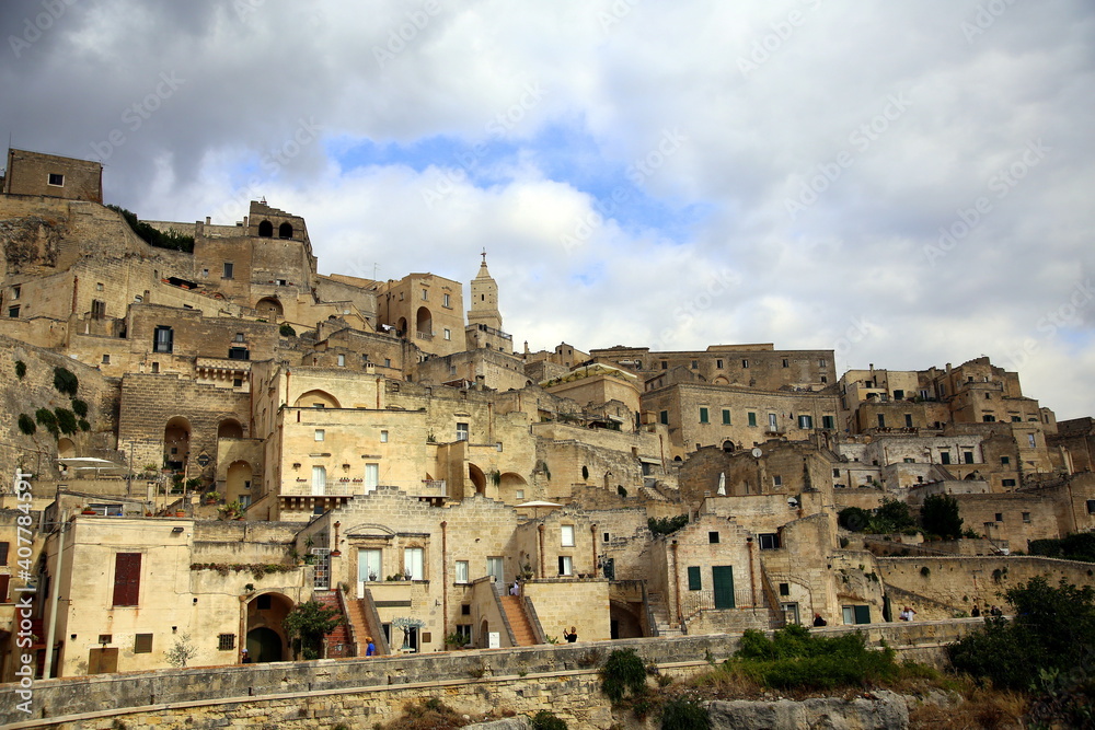 Cloudy blue sky over the structures of the houses of Sasso Barisano of Matera, European Capital of Culture 2019