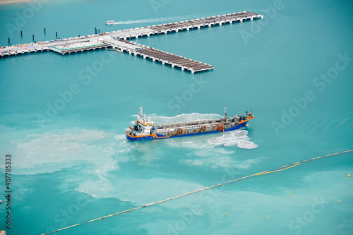 Fotografija Suction Dredger ship working near the port - with mud, Pollution, brown Muddy wa