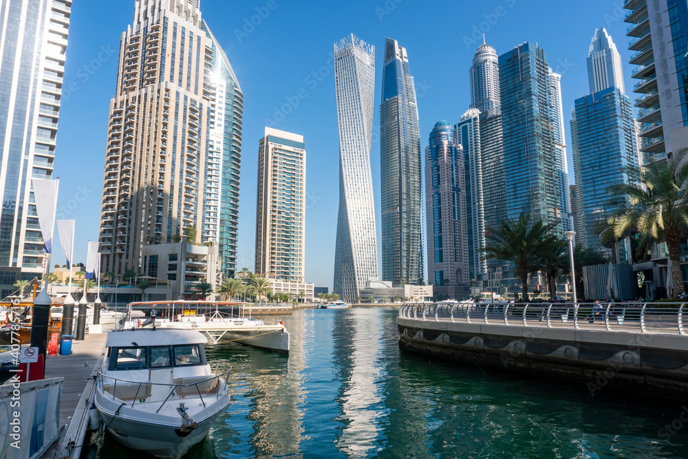 Fototapeta premium Yachts near Embarkment in Dubai Marina. Modern buildings in Dubai, UAE. In the city of artificial channel length of 3 kilometers along the Persian Gulf