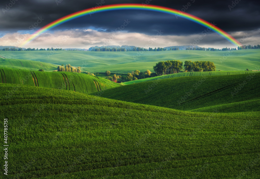 Scenic view of rainbow over green field. dramatic gray sky over a picturesque hilly field
Scenic view of rainbow over green field. dramatic gray sky over a picturesque hilly field