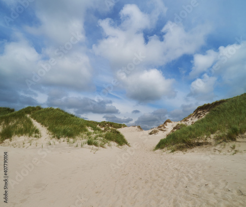 scenic blue sky and white clouds over the sand dunes at the beach Nymindegab Strand  Denmark on a sunny summer day
