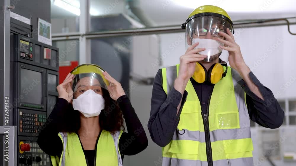 worker factory wearing face mask and face shied to safety face and prevent contamination of pollution and disease virus outbreak. New normal life of factory operation life in workplace industrial.