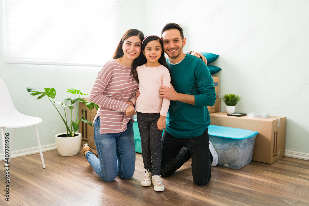 Latin parents smiling with their daughter during moving day Latin parents smiling with their daughter during moving day