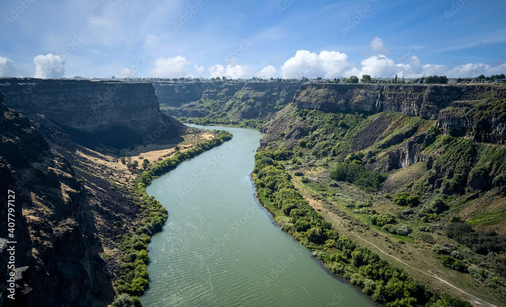 Winding Snake River flowing thru the pacific northwest in the summertime on a partly cloudy day