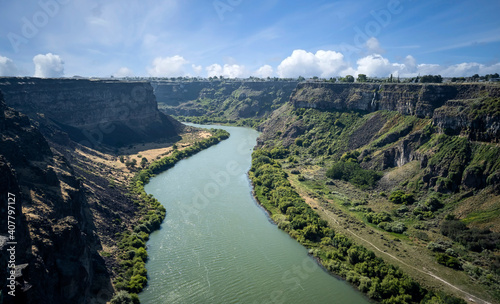 Winding Snake River flowing thru the pacific northwest in the summertime on a partly cloudy day