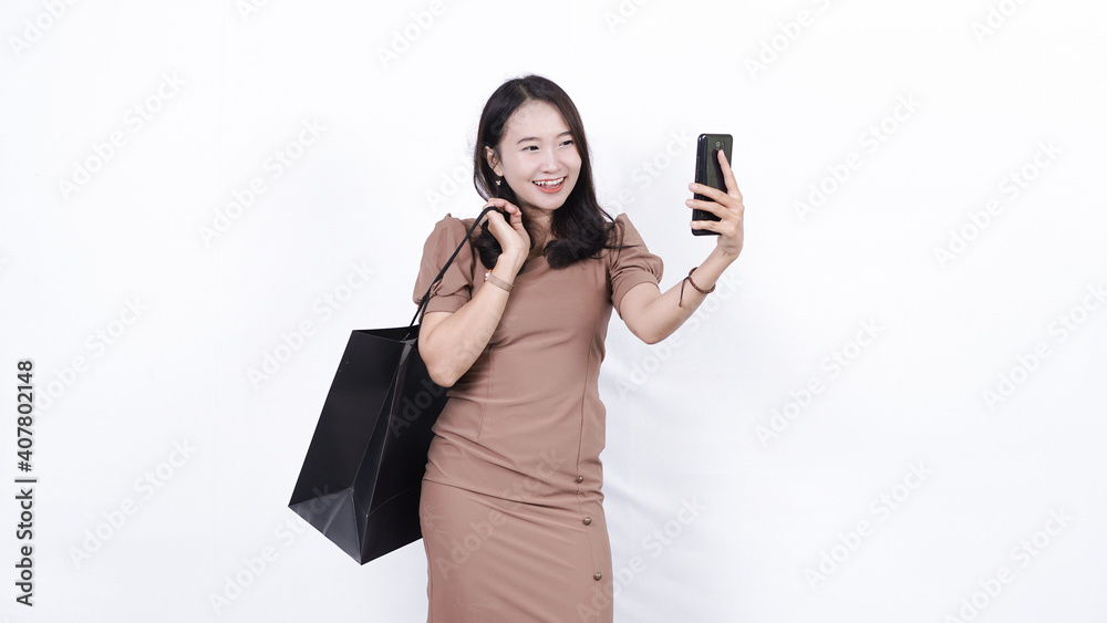 cheerful asian woman shopping playing phone isolated cheerful asian woman shopping playing phone isolated