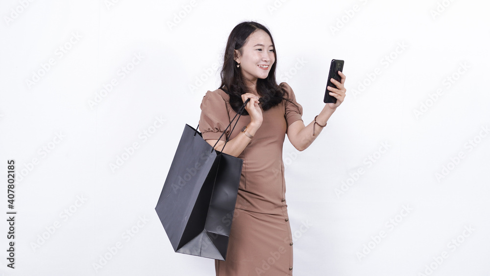 cheerful asian woman shopping playing phone isolated cheerful asian woman shopping playing phone isolated