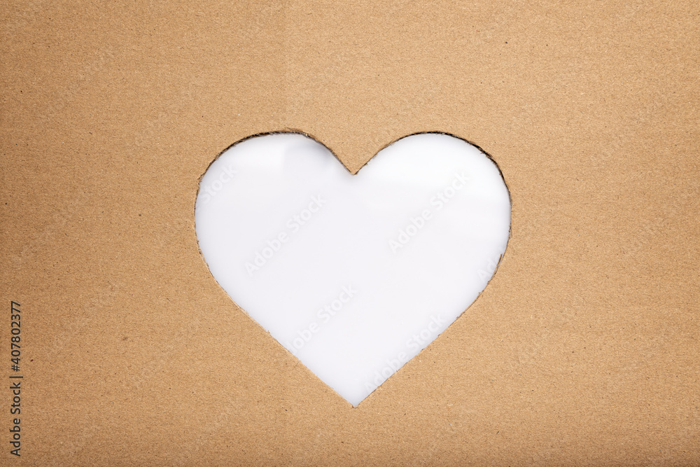love concept image of heart shape made in cut out of cardboard background with white copy space