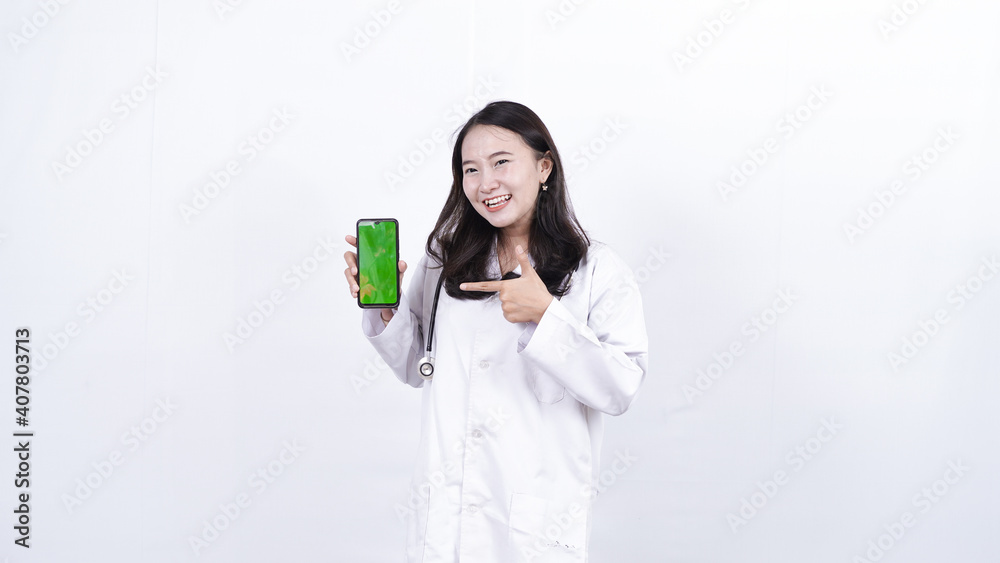 asian woman doctor holding green screen phone isolated white background asian woman doctor holding green screen phone isolated white background