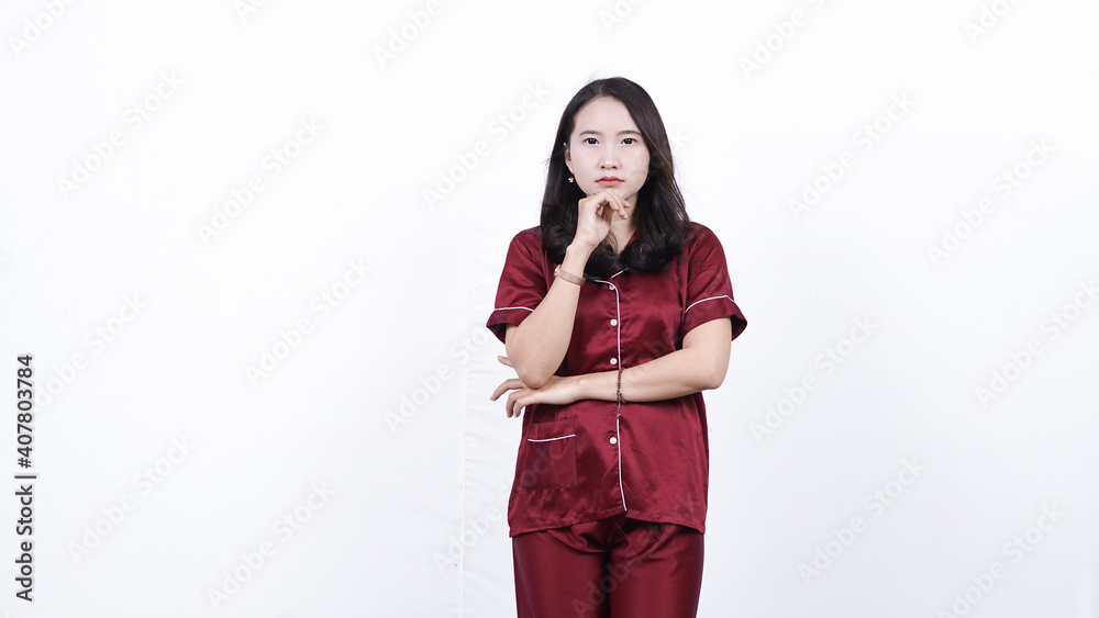 Asian woman wearing pajama thinking and get idea isolated white backiground Asian woman wearing pajama thinking and get idea isolated white backiground