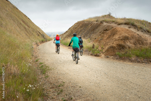 Three people cycling the Otago Central Rail Trail at Poolburn Gorge, South Island