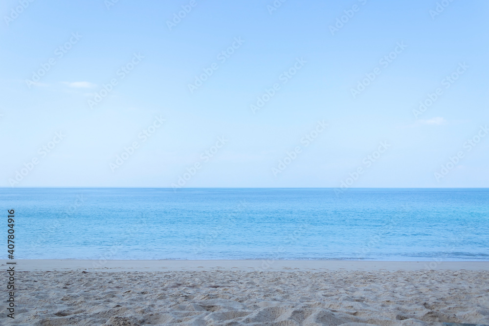 View of the sandy beach, summer sea and blue sky. View of the sandy beach, summer sea and blue sky.