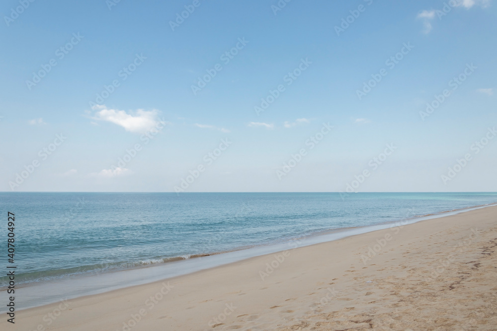 View of the sandy beach, summer sea and blue sky.