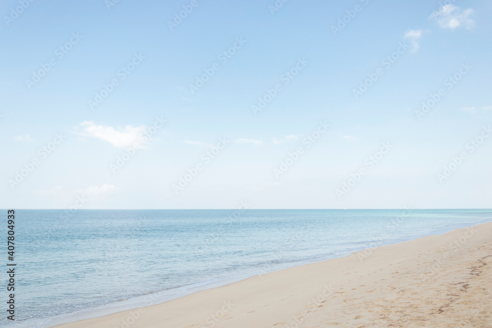 View of the sandy beach, summer sea and blue sky.