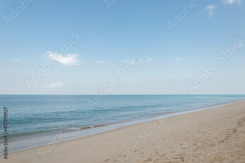 Fototapeta Naklejka Na Ścianę i Meble -  View of the sandy beach, summer sea and blue sky.