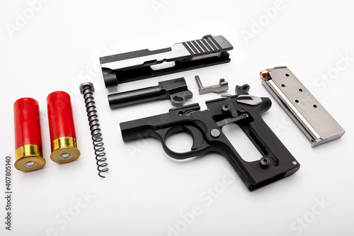 gun and shotgun bullets , Disassembled pocket handgun on white background