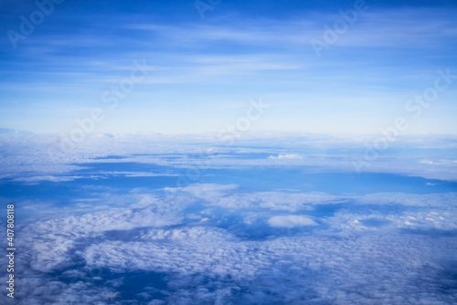 High view of blue sky and cloud from airplane window