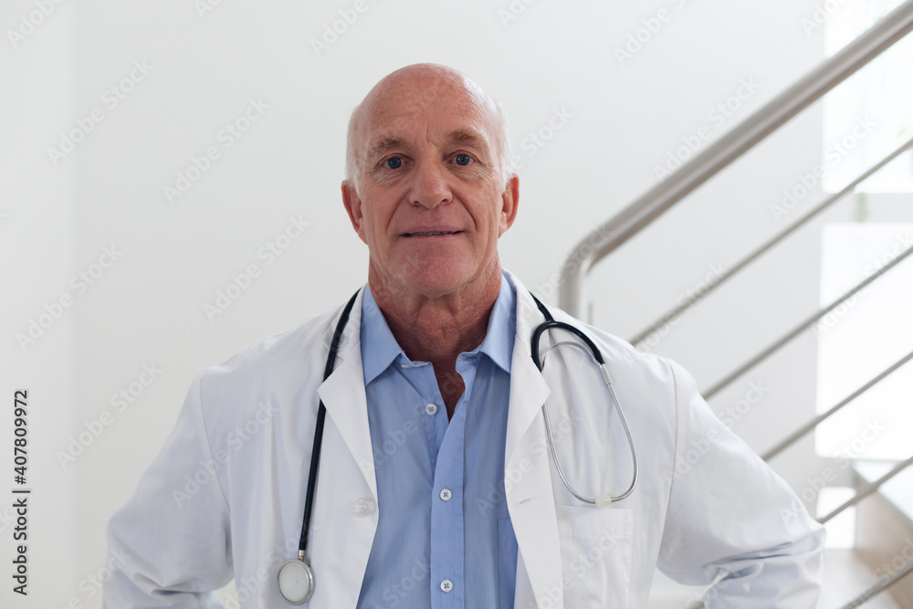 Portrait of senior caucasian male doctor looking at the camera and smiling Portrait of senior caucasian male doctor looking at the camera and smiling