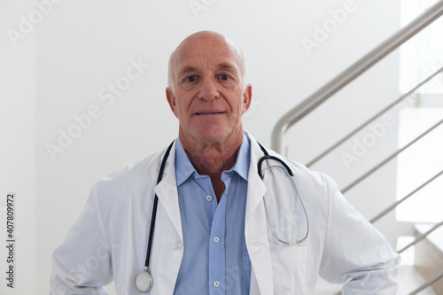 Portrait of senior caucasian male doctor looking at the camera and smiling photo