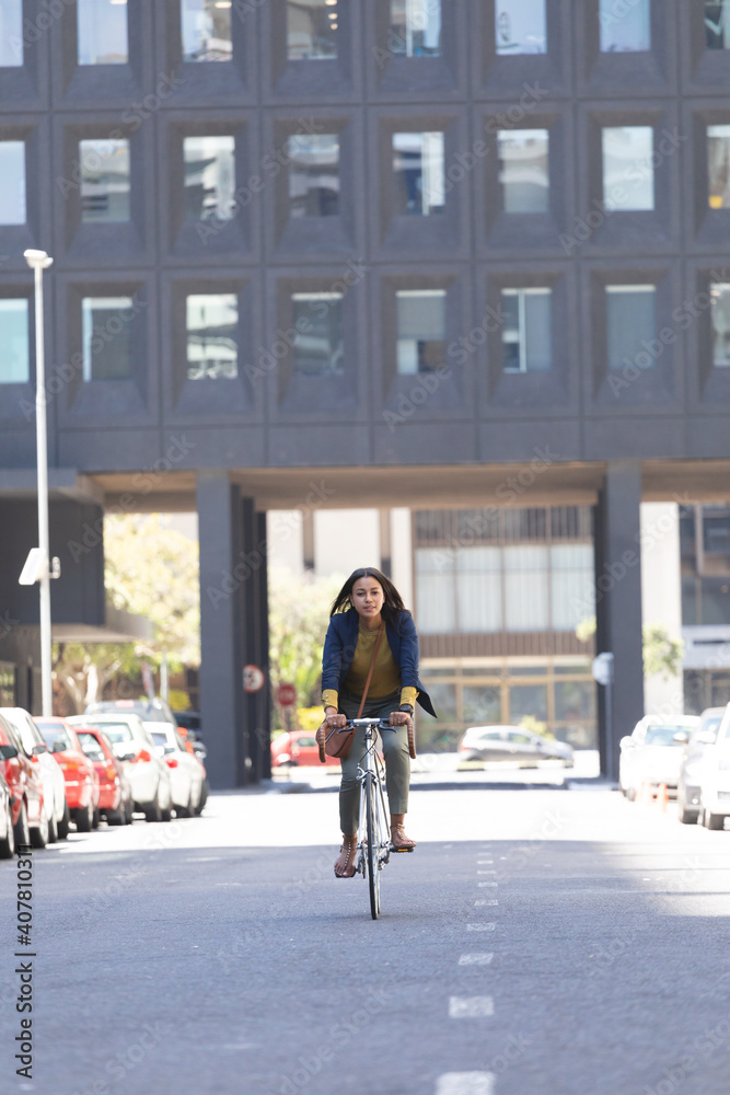 African american woman riding bicycle on the street African american woman riding bicycle on the street