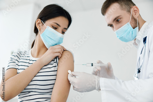 male doctor injecting vaccine into shoulder patient health coronavirus
