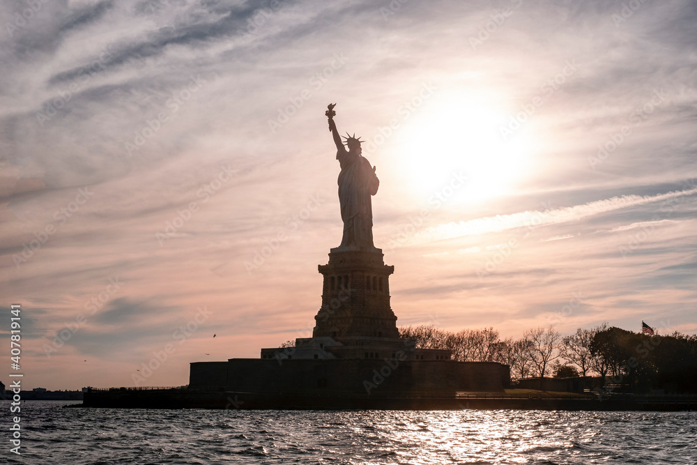 View of Statue of Liberty against cloudy sky during sunset View of Statue of Liberty against cloudy sky during sunset