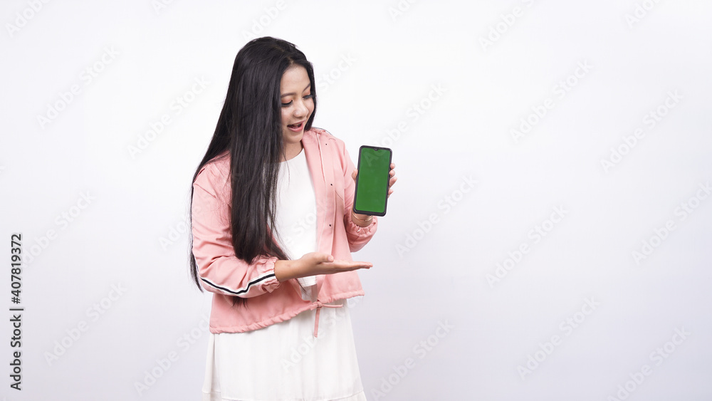 beautiful asian woman pointing green screen in handphone isolated white background beautiful asian woman pointing green screen in handphone isolated white background