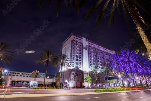 Long exposure night view of traffic passing along a street in downtown Anaheim, California, USA.
