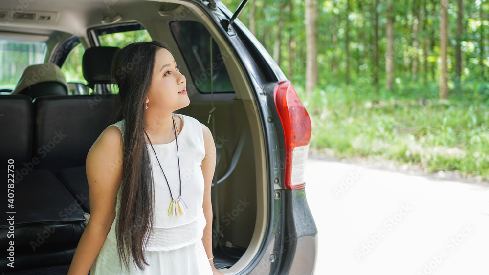 portrait of happy asian woman travelling in back car