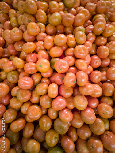 Bright orange tangerines a bunch of fruity background