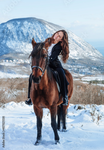 young woman with horse in winter 