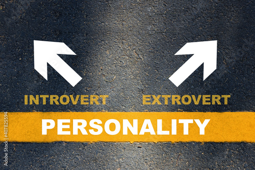 Personality written on yellow line with introvert and extrovert with white arrow on asphalt road. Shy or outgoing person concept and understanding relationship in your life idea