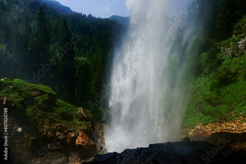 huge waterfall from a high cliff with view to the forest © thomaseder