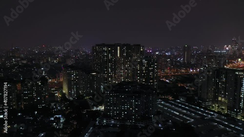 Wallpaper Mural Drone crane shot at night of big city lights from main roads bridges and buildings. Scene includes riverfront with reflections and moving traffic.. Torontodigital.ca