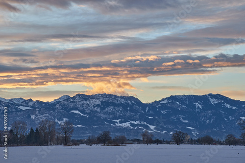 Sunrise over snowy mountain landscape © Thomas