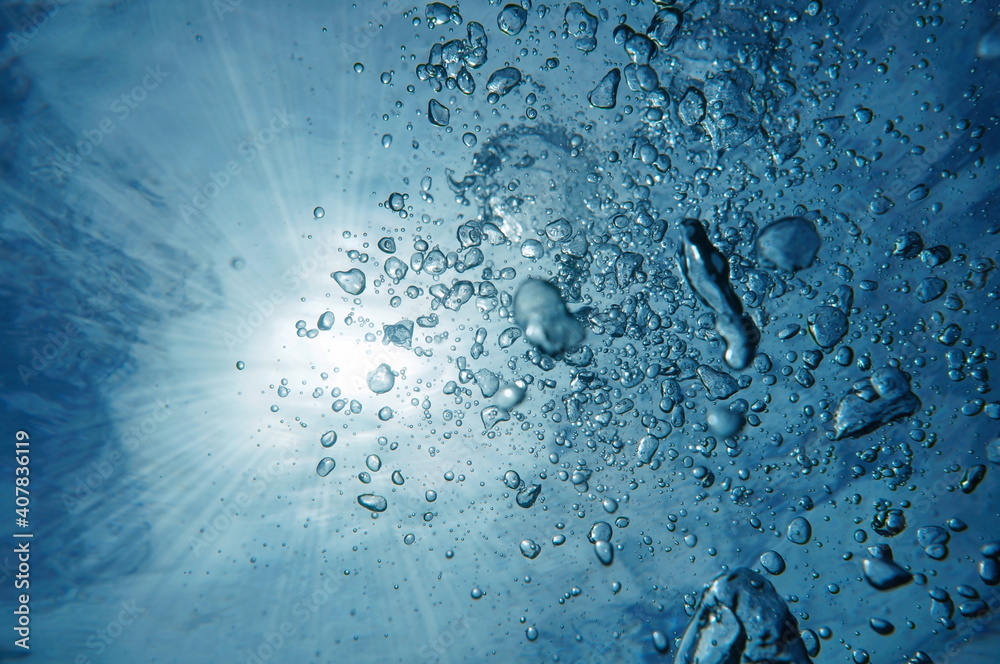 Air bubbles underwater with sunlight through water surface, Caribbean sea