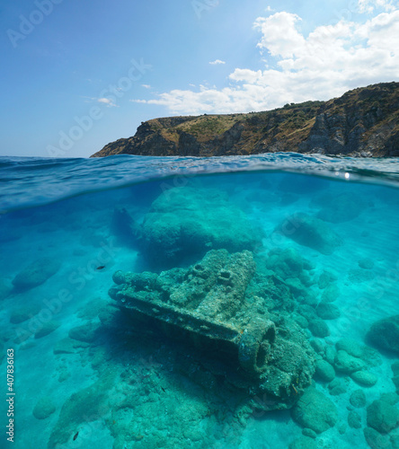 Fototapeta Naklejka Na Ścianę i Meble -  France Occitanie, rocky coast and the remains of a wrecked ship underwater, split view over and under water surface, Mediterranean sea, Marine reserve of Cerbere Banyuls
