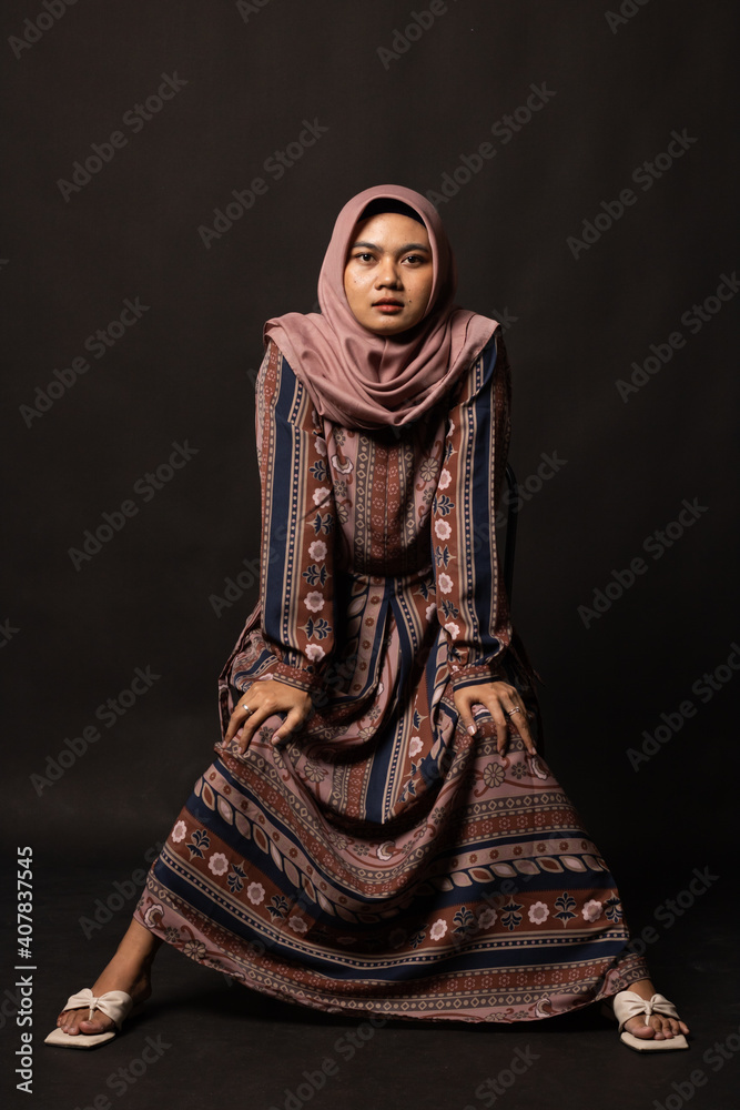 Fashion portrait of young beautiful asian muslim woman with wearing hijab on black background