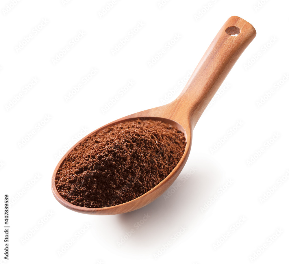 Ground coffee in a wooden spoon isolated on white background Ground coffee in a wooden spoon isolated on white background