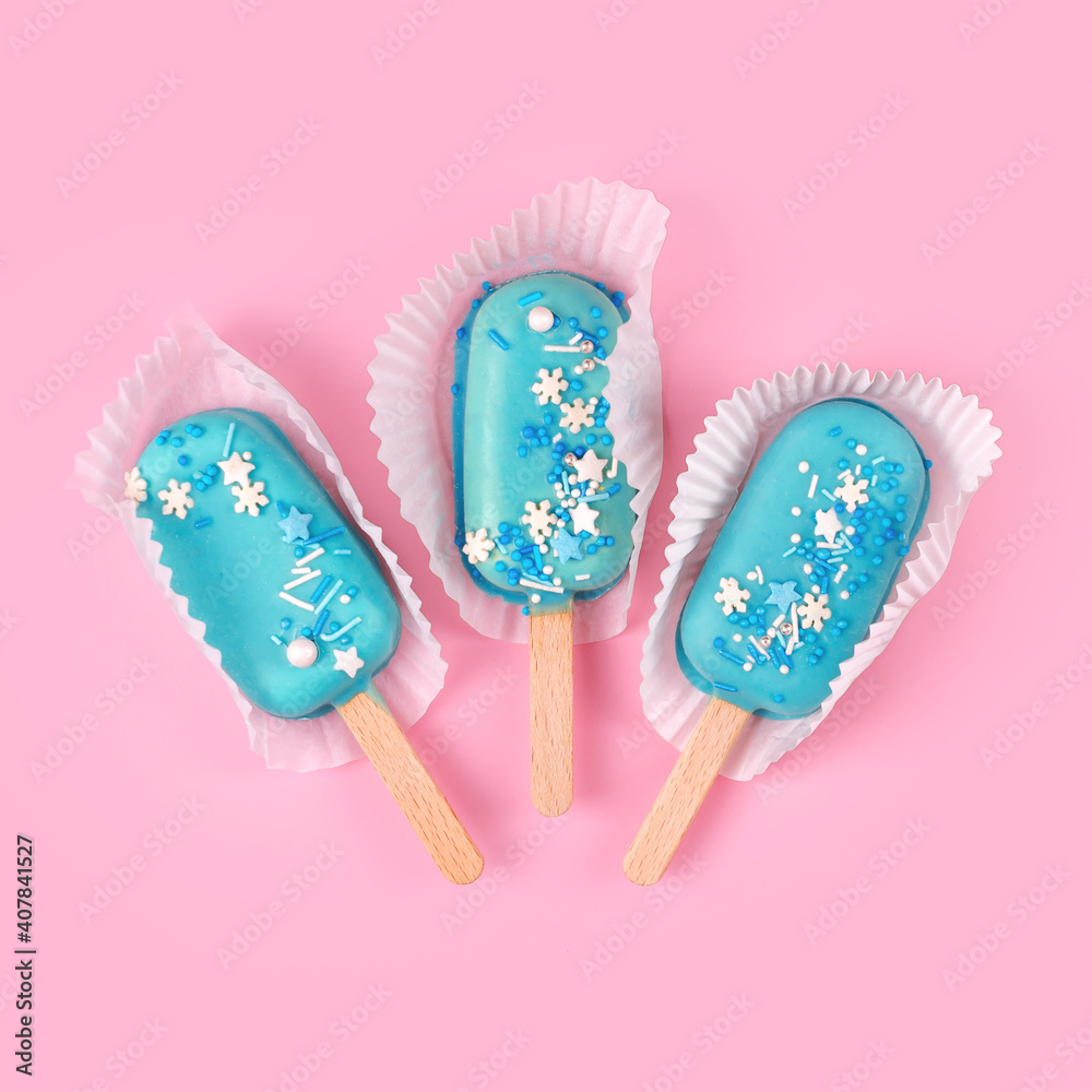Blue mint ice cream popsicles on pastel pink background. Tasty and refreshing icecream on sticks. Minimal summer concept. Flat lay