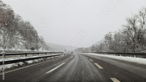 winter road and snow with landscape of trees with frost, road landscape in winter . Asphalt road with sideways full of snow