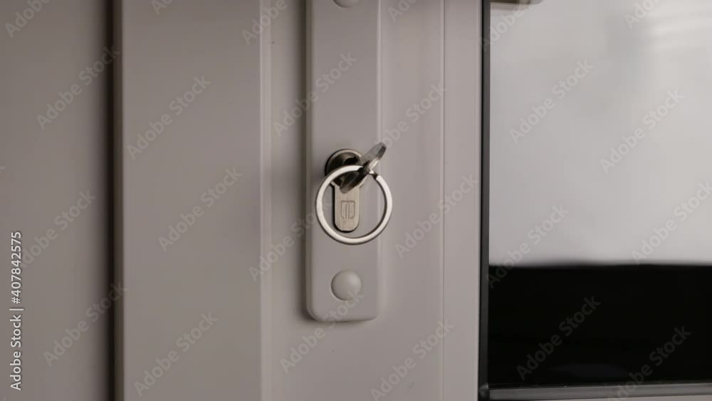 insertion of the key and unlocking the door. close up view insertion of the key and unlocking the door. close up view