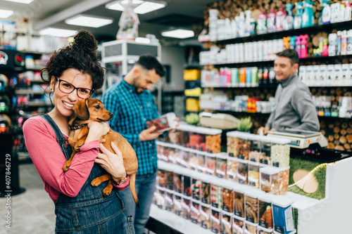 Customers buying accessories and food for their pet in pet shop. photo